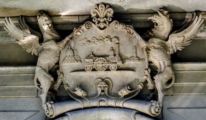 A steam train is the centrepiece of the escutcheon above the entrance to Palazzo Fenzi in Florence