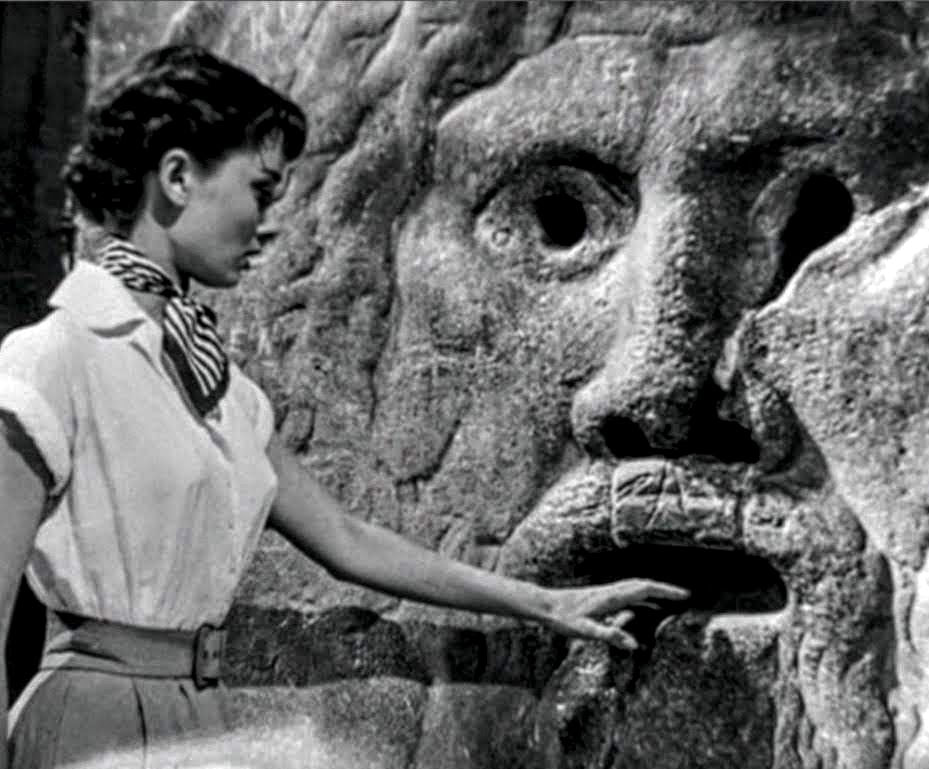 Audrey Hepburn puts her hand in the Mouth of Truth in the movie Roman Holiday (1953)