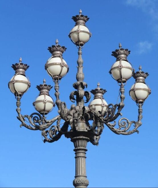 A detail of one of the four wrought-iron lamp-posts in St Peter's Square, Rome