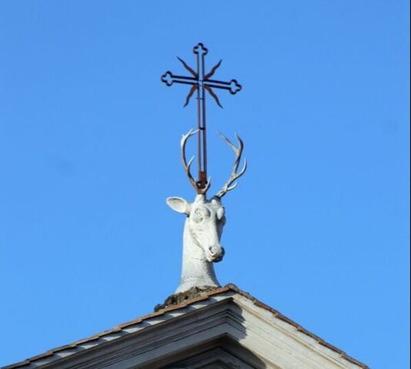 A stag's head, bearing a cross betwixt its antlers, crowns the church of Sant' Eustachio, Rome