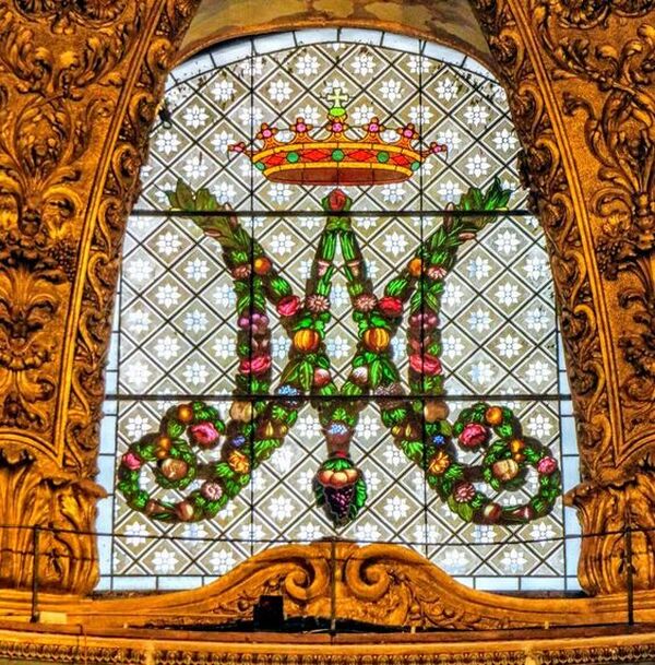 An 18th century stained glass window depicting the monogram of the Virgin Mary, church of Santa Maria dell' Orto, Rome